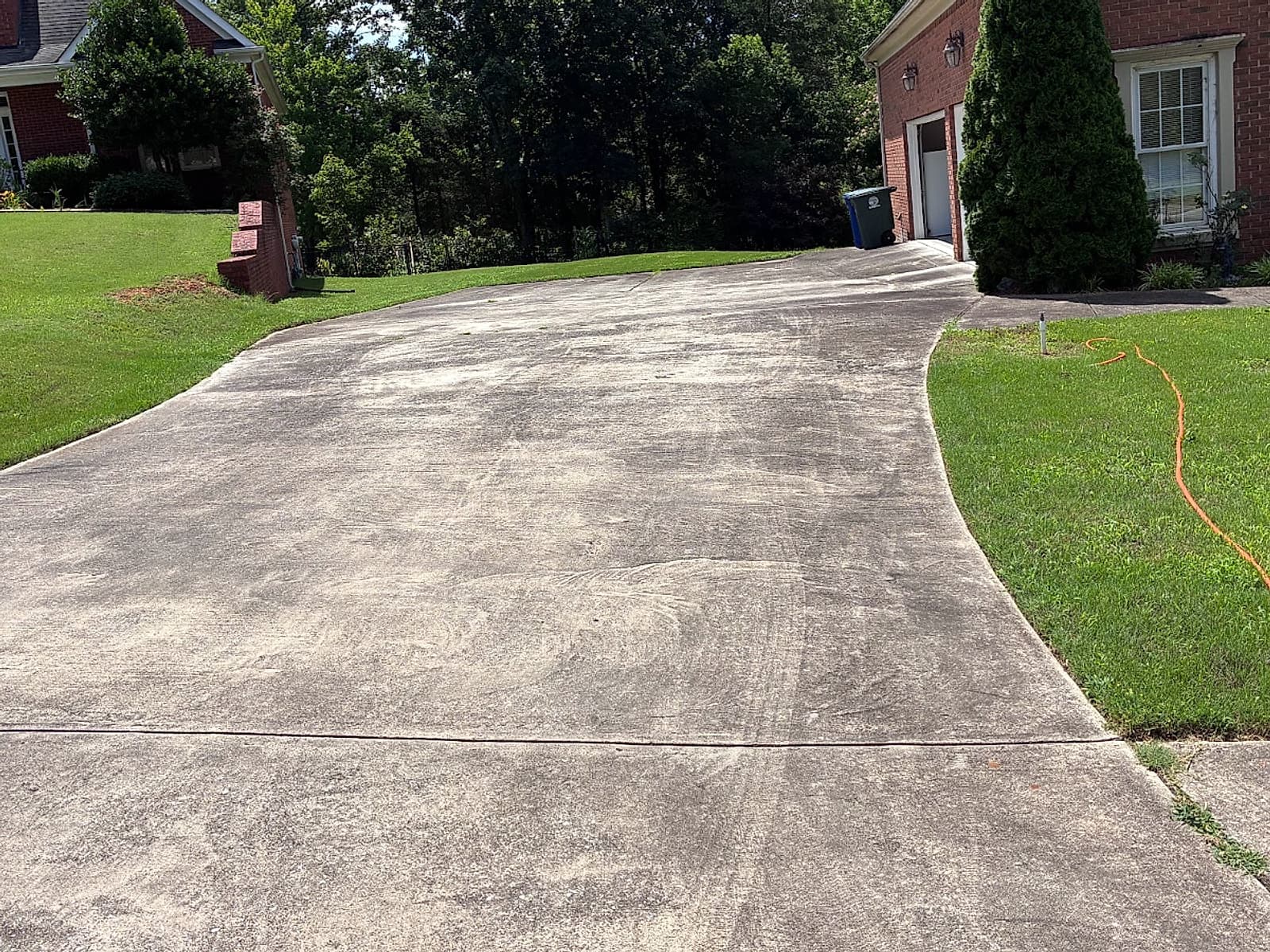 Grimy, stained concrete driveway before pressure washing
