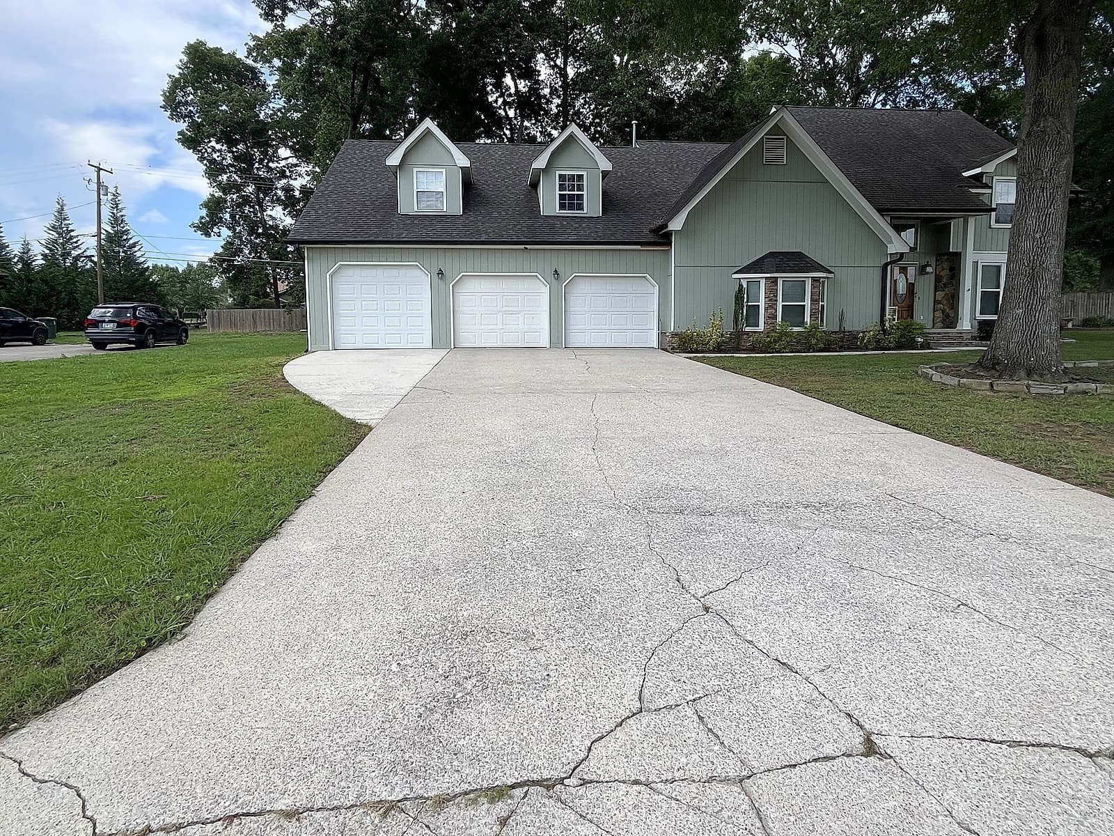 Bright, clean three-car driveway after pressure washing