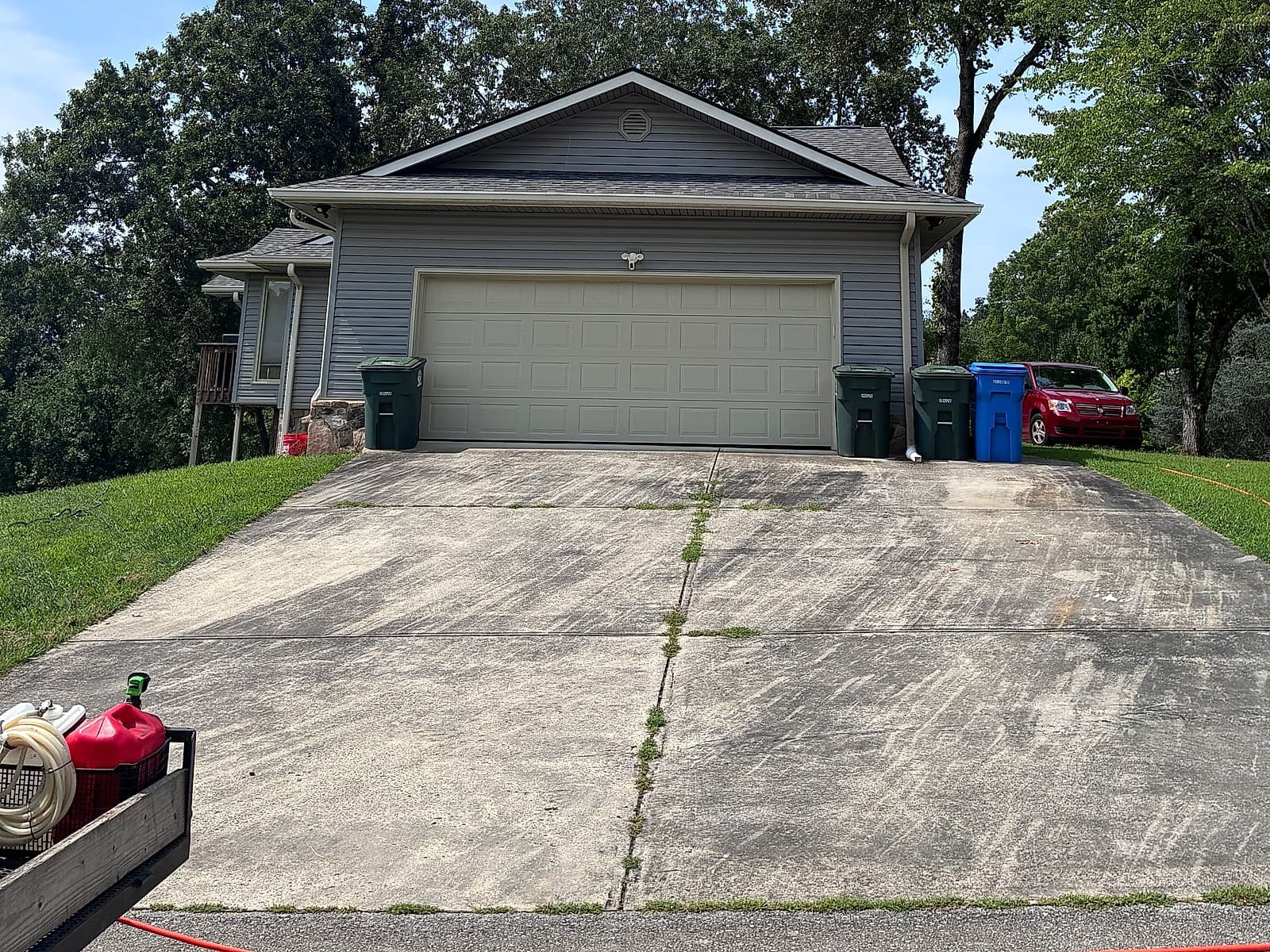 Streaked, dirt-stained two-car driveway before pressure washing