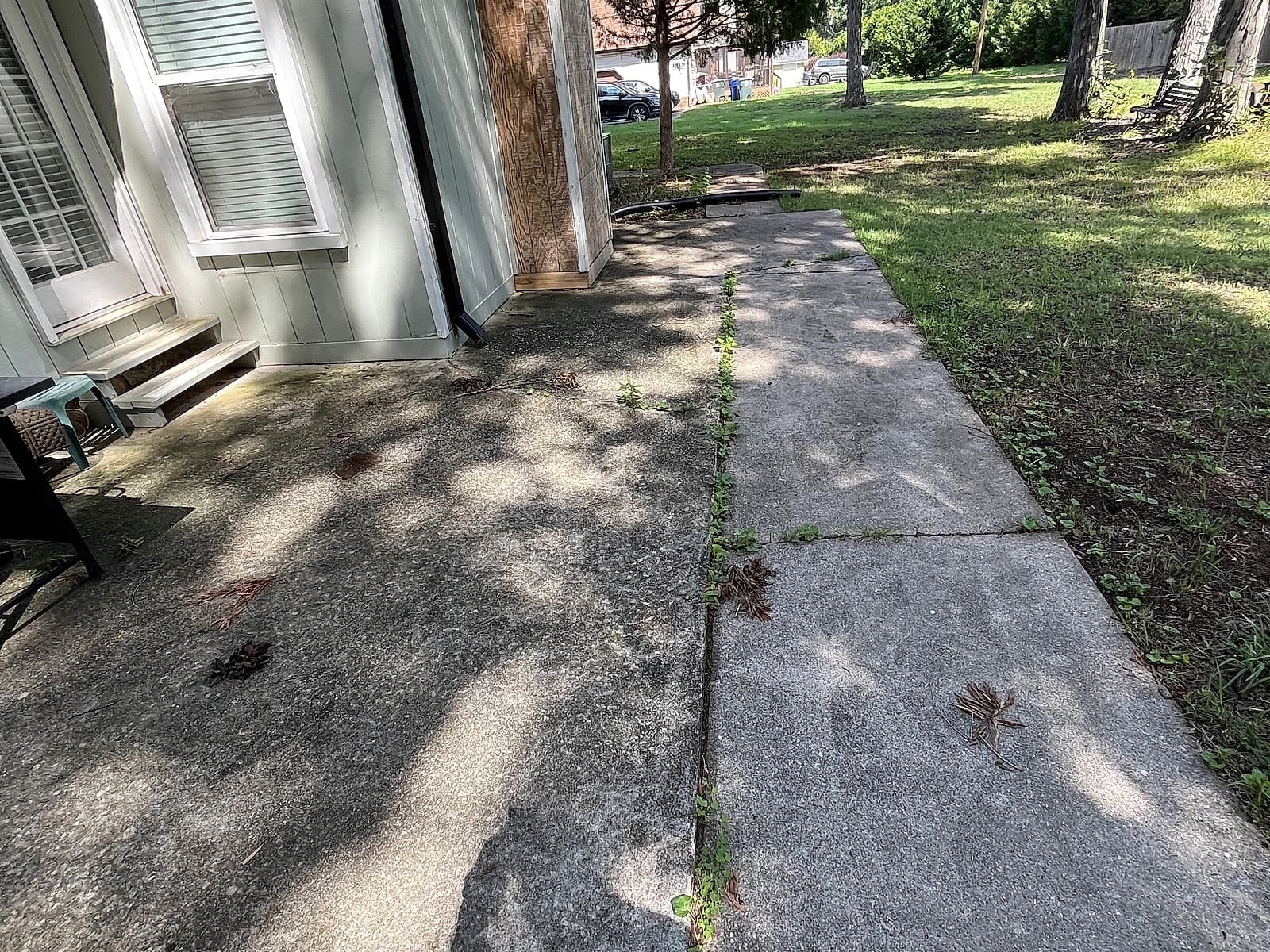 Dirty, mildew-stained back patio and walkway before cleaning