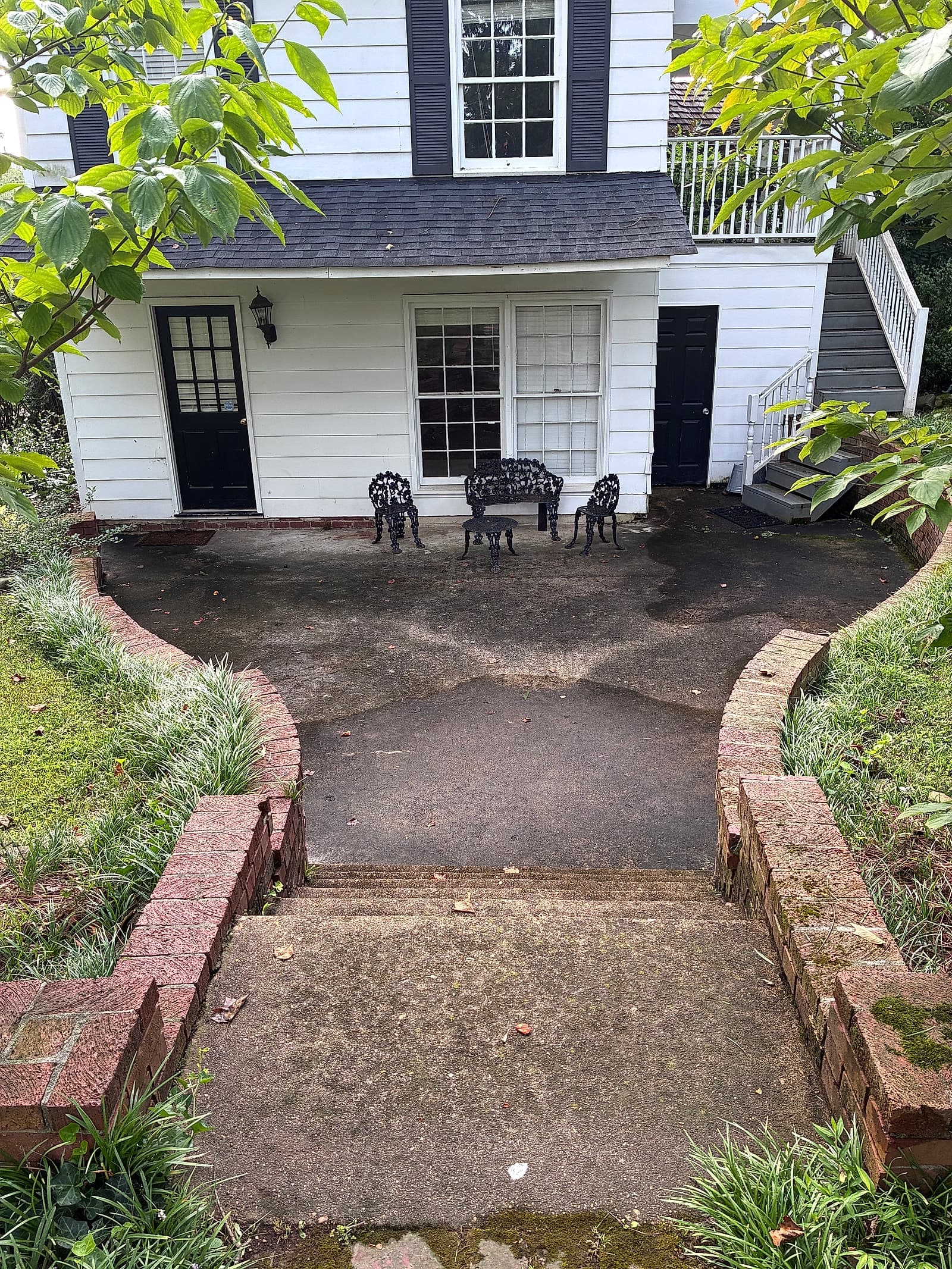 Dark, grimy brick patio and steps before pressure washing